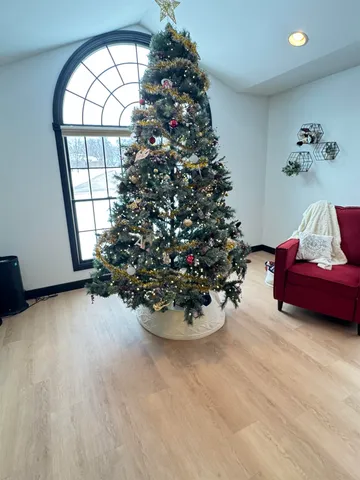 a living room with furniture and a floor to ceiling window next to a large window