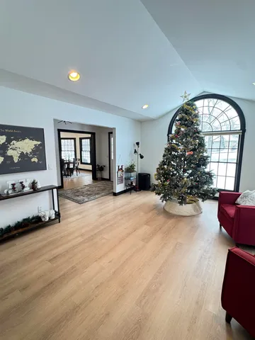 a front view of a house with a yard and trees