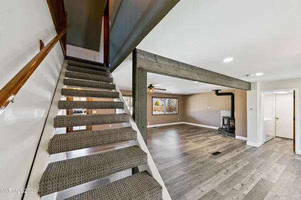 a view of a livingroom with a ceiling fan and window