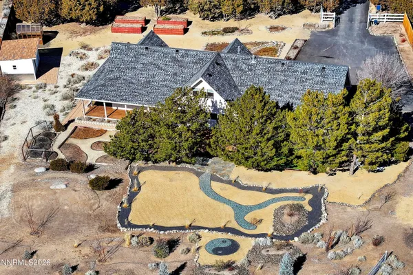 a view of a house with wooden fence
