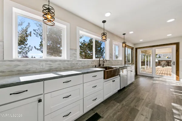 a kitchen with stainless steel appliances granite countertop a refrigerator a stove and a wooden floors