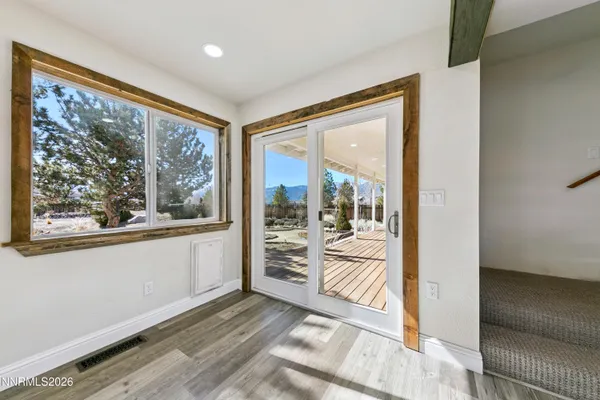 a view of a hallway view with wooden floor and staircase