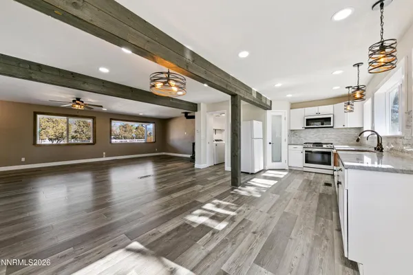 a bathroom with a granite countertop sink a toilet and shower