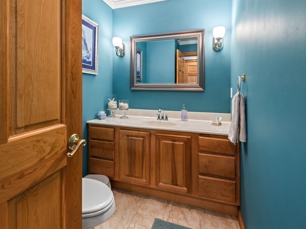9 Santom Street Auburn, MA 01501 - Photo 16 of 42 a bathroom with a sink a toilet and mirror