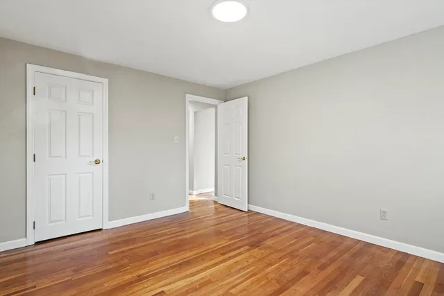 a view of room with wooden floor