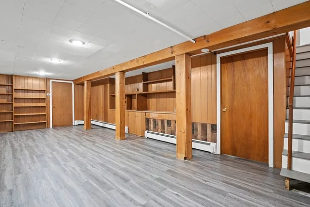 an empty room with wooden floor and closet
