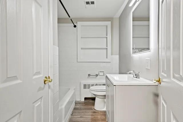 a bathroom with a sink a toilet and tub