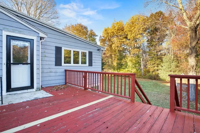 a view of backyard with deck and wooden floor
