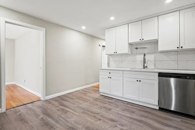 a kitchen with stainless steel appliances white cabinets and a sink