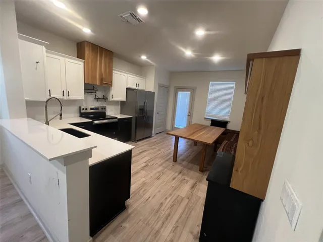 a kitchen with a sink stove and refrigerator
