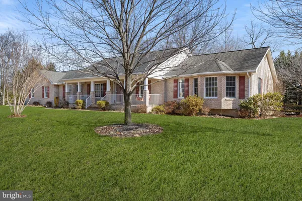 a front view of a building with a garden