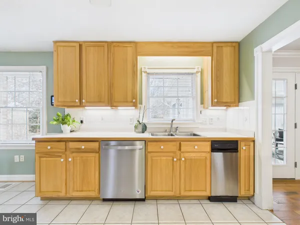 a kitchen with stainless steel appliances a stove a refrigerator and cabinets
