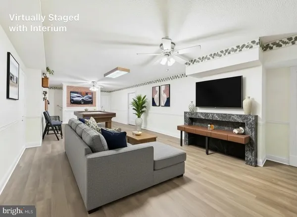 a spacious bedroom with a bed and a chandelier