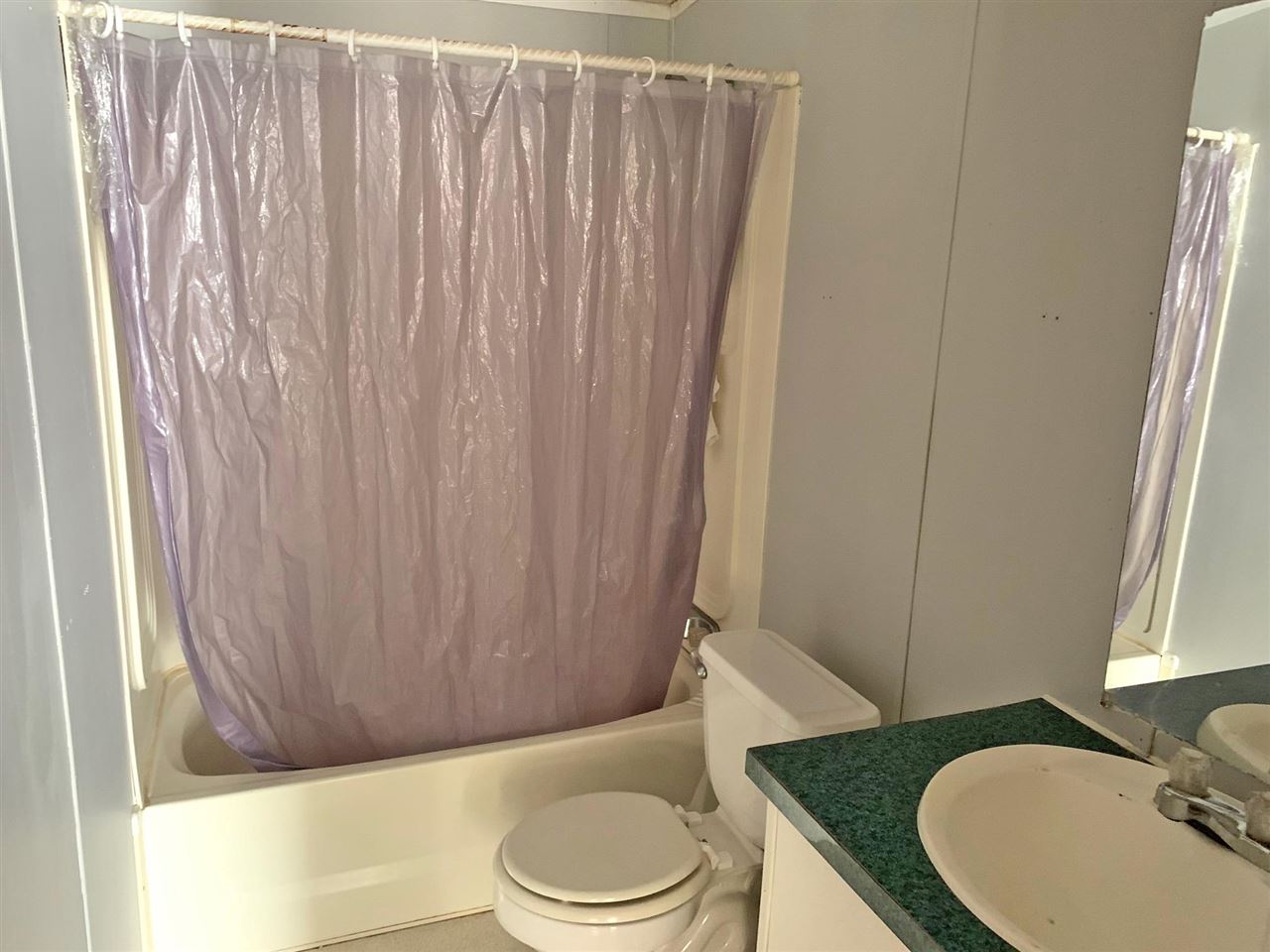2176 Puron Road Adamsville, TN 38310 - Photo 11 of 24 a bathroom with a granite countertop sink and a toilet