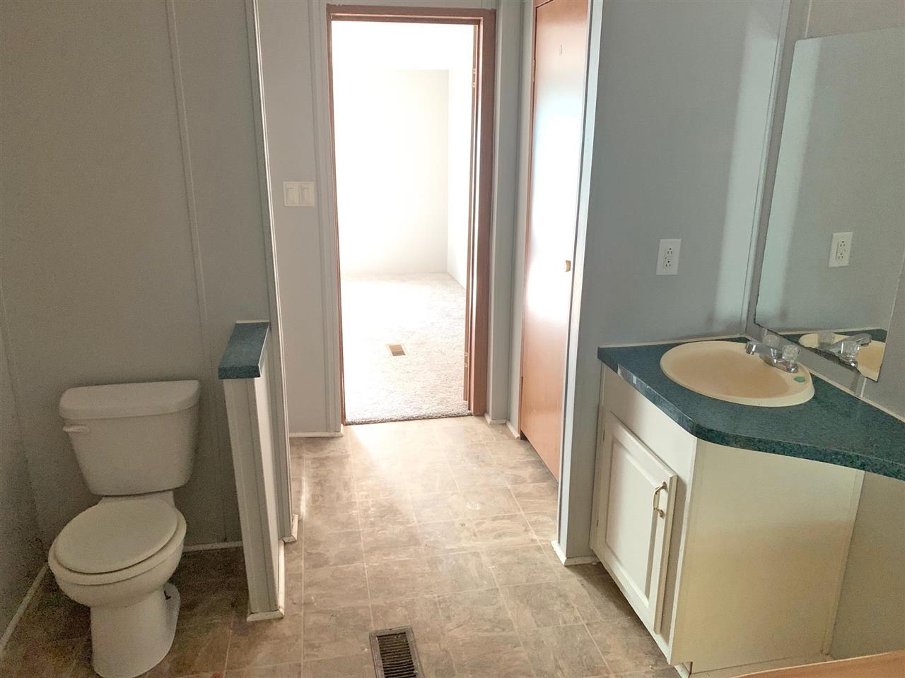 2176 Puron Road Adamsville, TN 38310 - Photo 9 of 24 a bathroom with a granite countertop sink toilet and shower