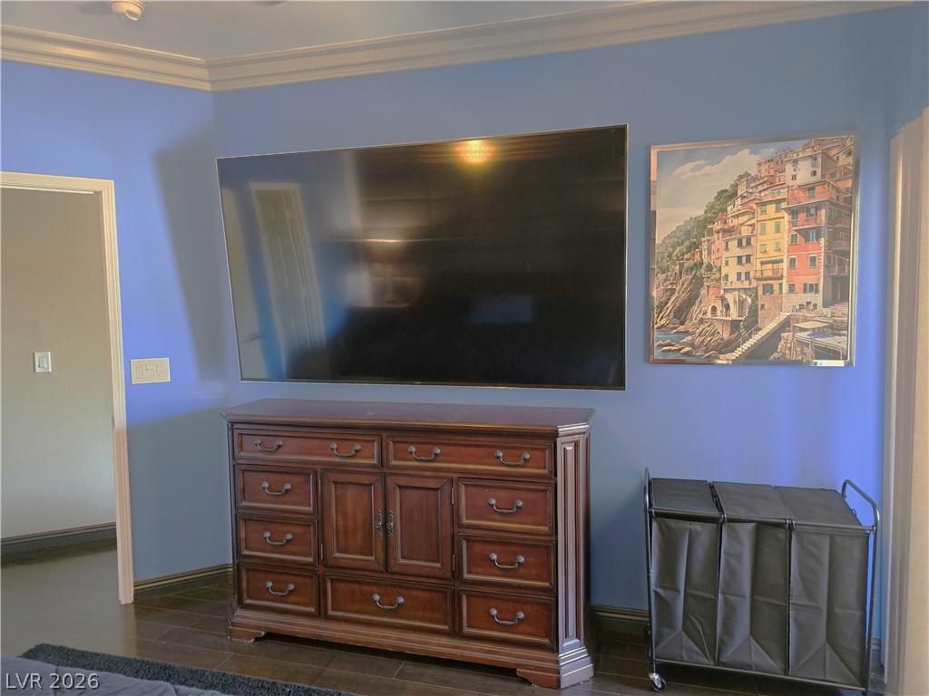 2050 West Warm Springs Road, Unit 2422 Henderson, NV 89014 - Photo 21 of 44 This spacious bedroom features crown molding and hardwood flooring for a refined retreat.