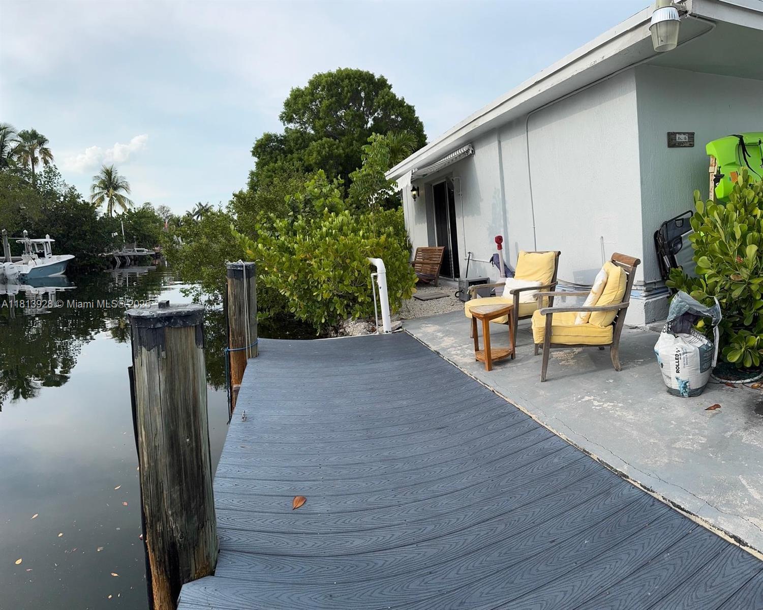 a view of a patio with table and chairs potted plants with wooden floor