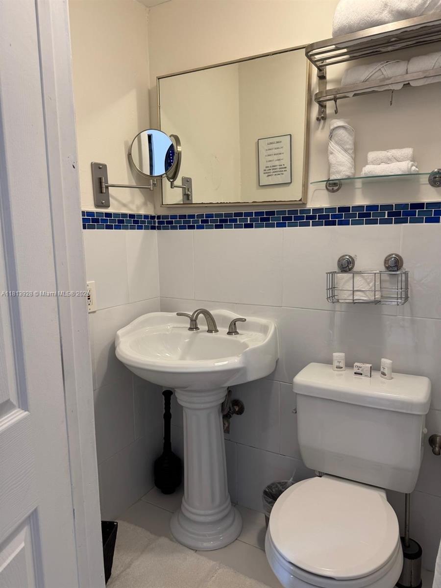 1301 Grouper Drive, Unit B Marathon, FL 33050 - Photo 11 of 39 a bathroom with a sink a toilet and mirror