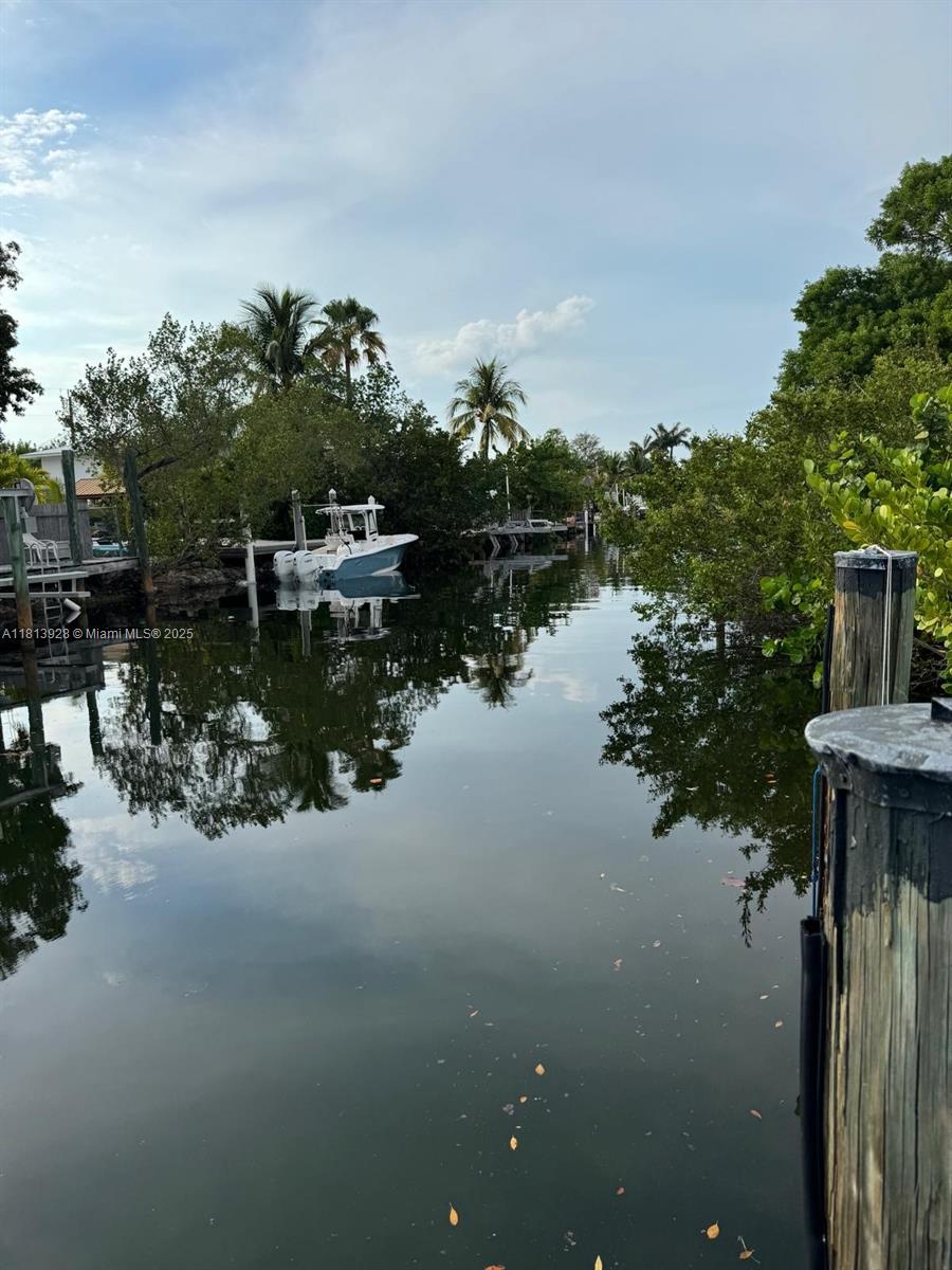 1301 Grouper Drive, Unit B Marathon, FL 33050 - Photo 3 of 39 a view of a lake with boats and trees in the background