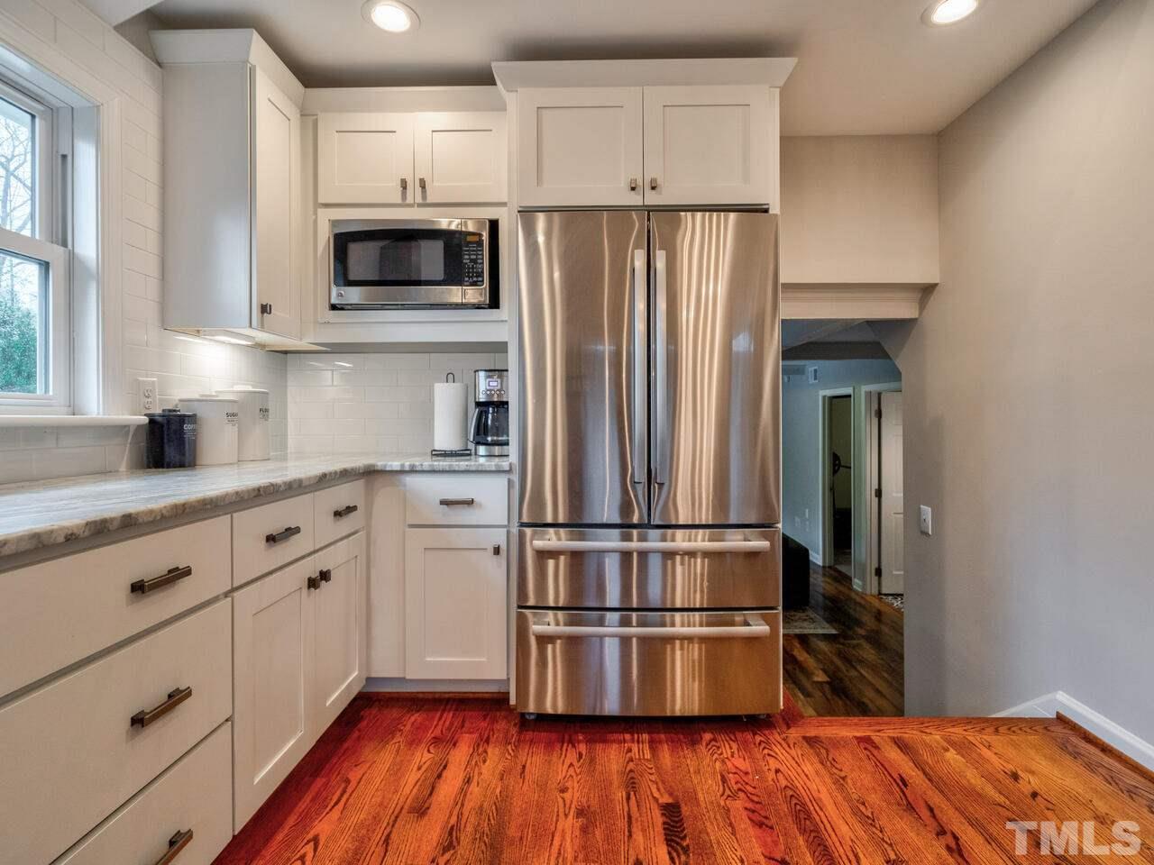 1201 Chardon Court Raleigh, NC 27609 - Photo 14 of 30 a kitchen with wooden floors and appliances
