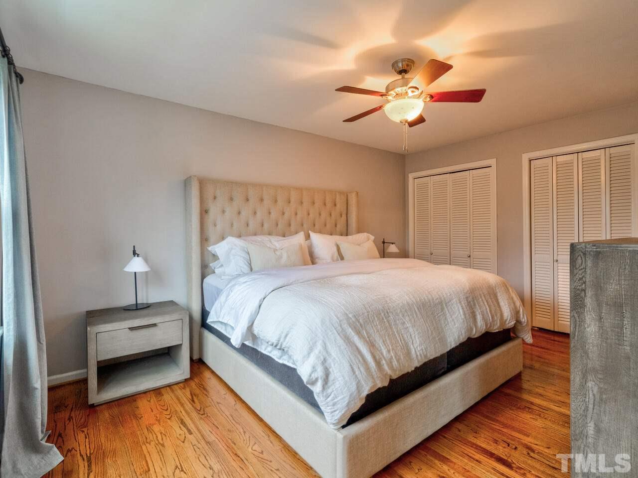 1201 Chardon Court Raleigh, NC 27609 - Photo 17 of 30 a bedroom with bed and a chandelier