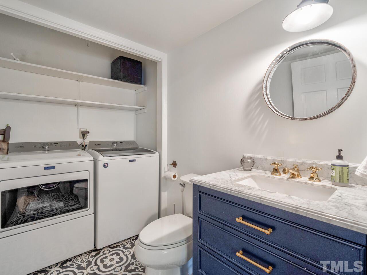 1201 Chardon Court Raleigh, NC 27609 - Photo 25 of 30 a bathroom with a sink a toilet and a mirror