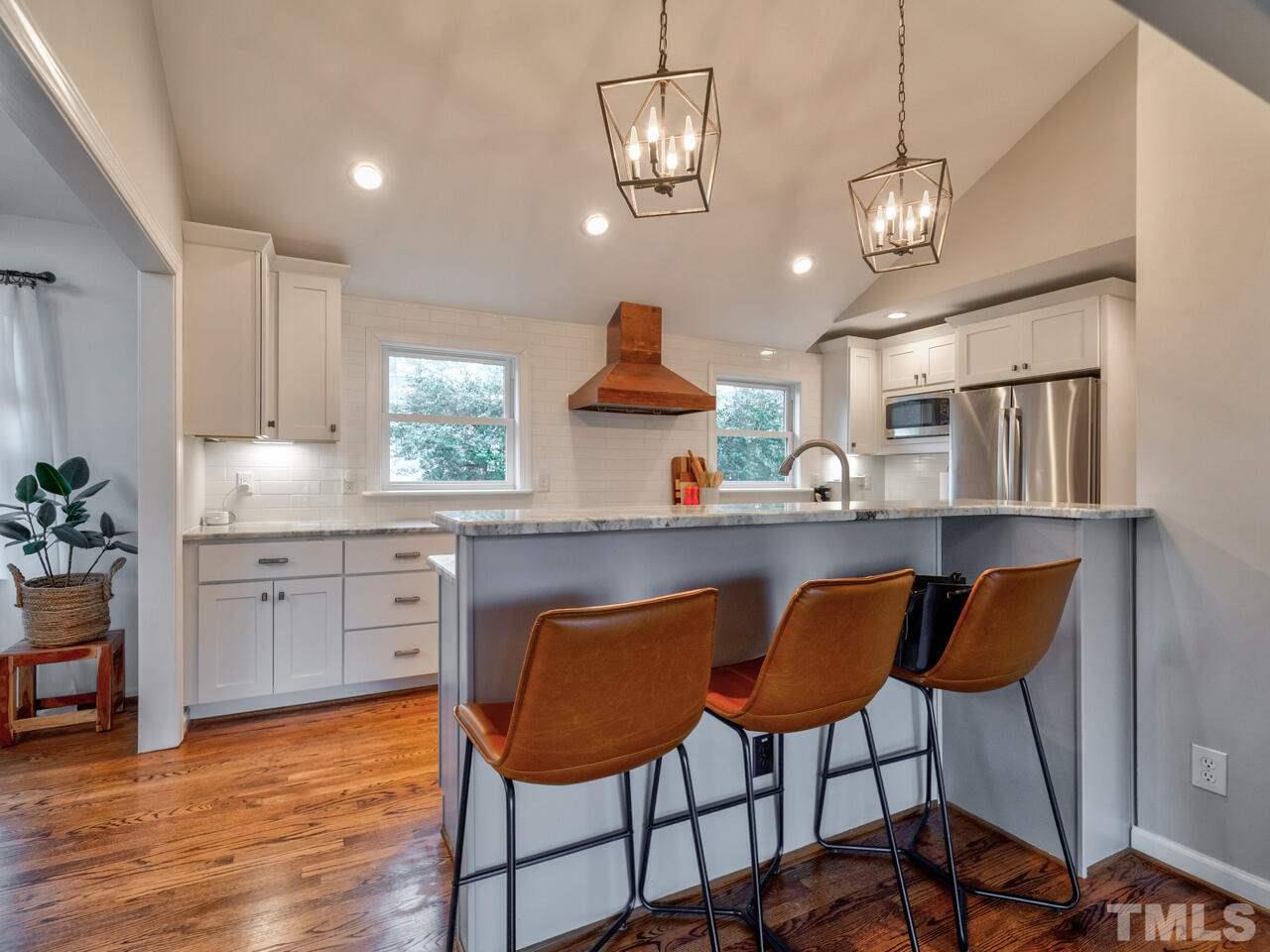 1201 Chardon Court Raleigh, NC 27609 - Photo 10 of 30 a kitchen with stainless steel appliances granite countertop a stove a sink and a refrigerator
