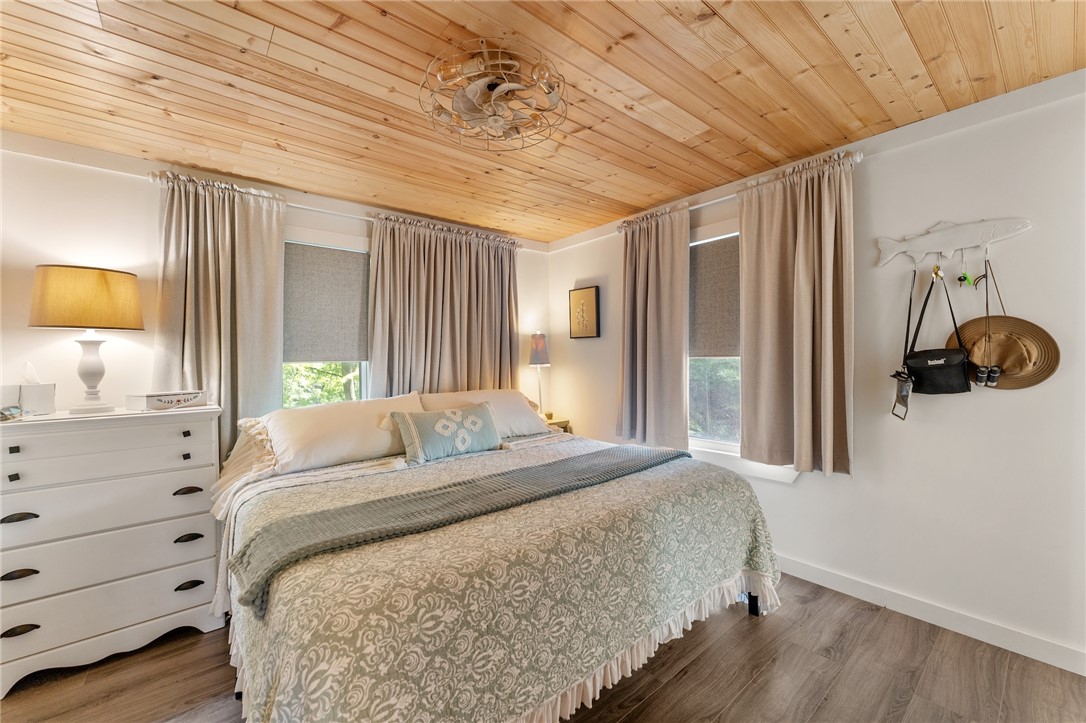 30 Mobleys Bluff Road Abbeville, SC 29620 - Photo 16 of 35 Warm wood ceilings and matching plank flooring create a cozy retreat in this bedroom.