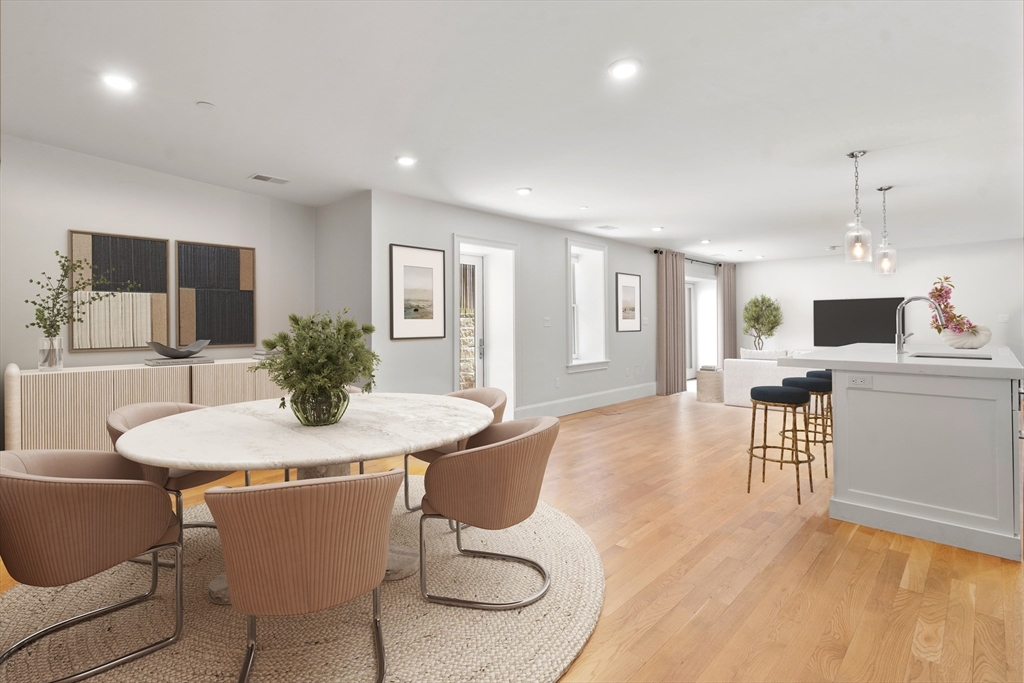 59 Addington Road, Unit 1 Brookline, MA 02445 - Photo 3 of 11 a living room with furniture a dining table and kitchen view