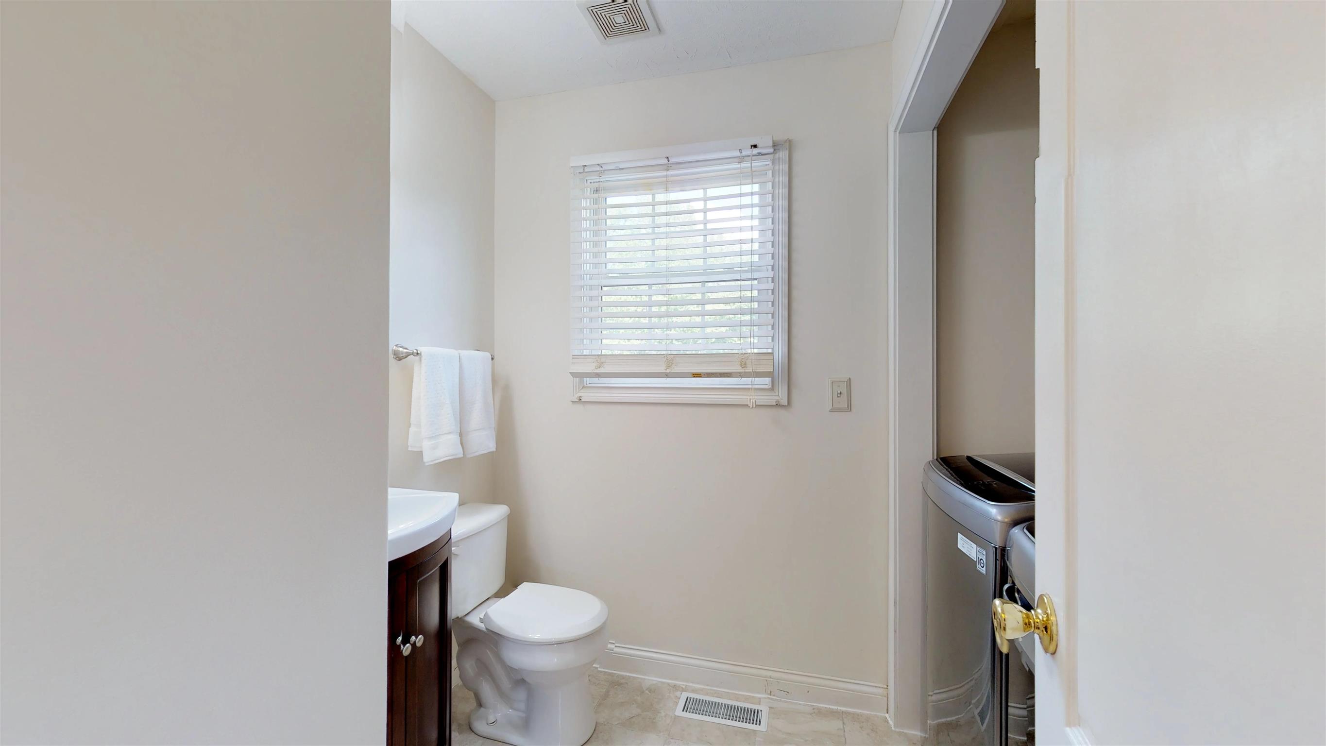 129 Fairfield Road Portland, TN 37148 - Photo 16 of 25 Half bath and laundry on main level are conveniently located across from the master bedroom.