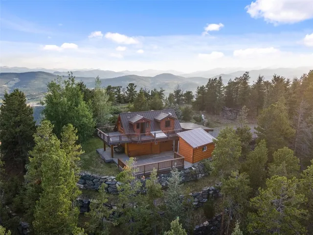 an aerial view of a house with mountain view
