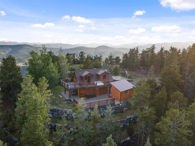 an aerial view of a house with mountain view