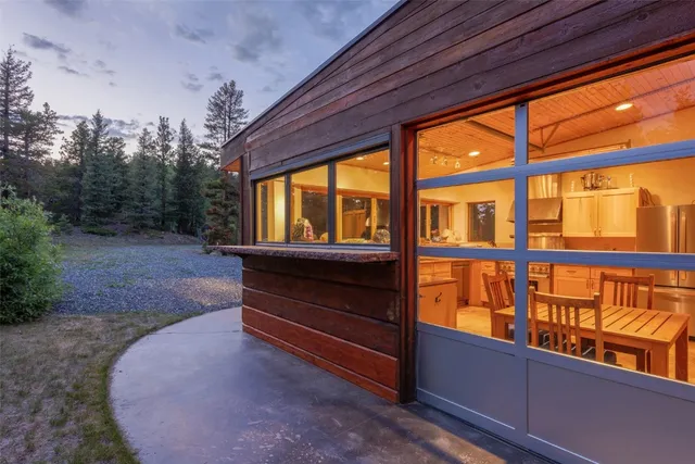 a backyard of a house with table and chairs