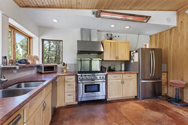 a kitchen with a sink and large window