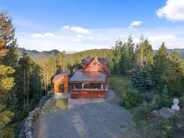 a view of a town with large trees & fence