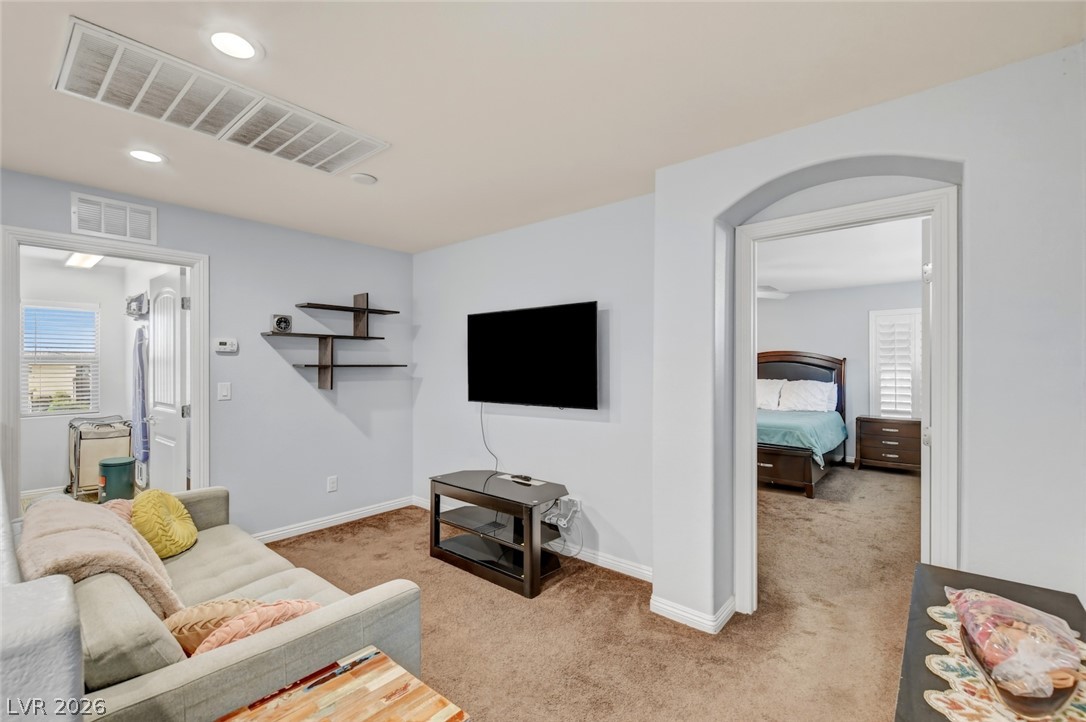 48 Jasmine Point Street Henderson, NV 89074 - Photo 31 of 62 A versatile secondary living space with durable carpeting connects to private rooms for comfortable living.