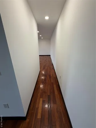 a view of gallery with wooden floor