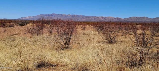 a view of mountain with sunset in background