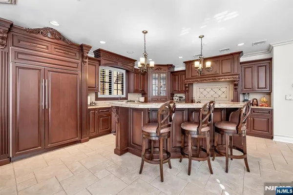 a kitchen with stainless steel appliances granite countertop a stove top oven a sink and dishwasher