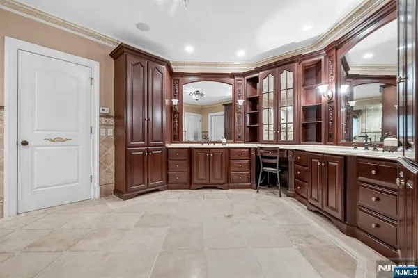 a spacious bathroom with a double vanity sink and a large mirror
