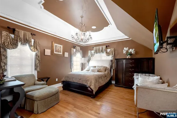 a bedroom with furniture and a chandelier
