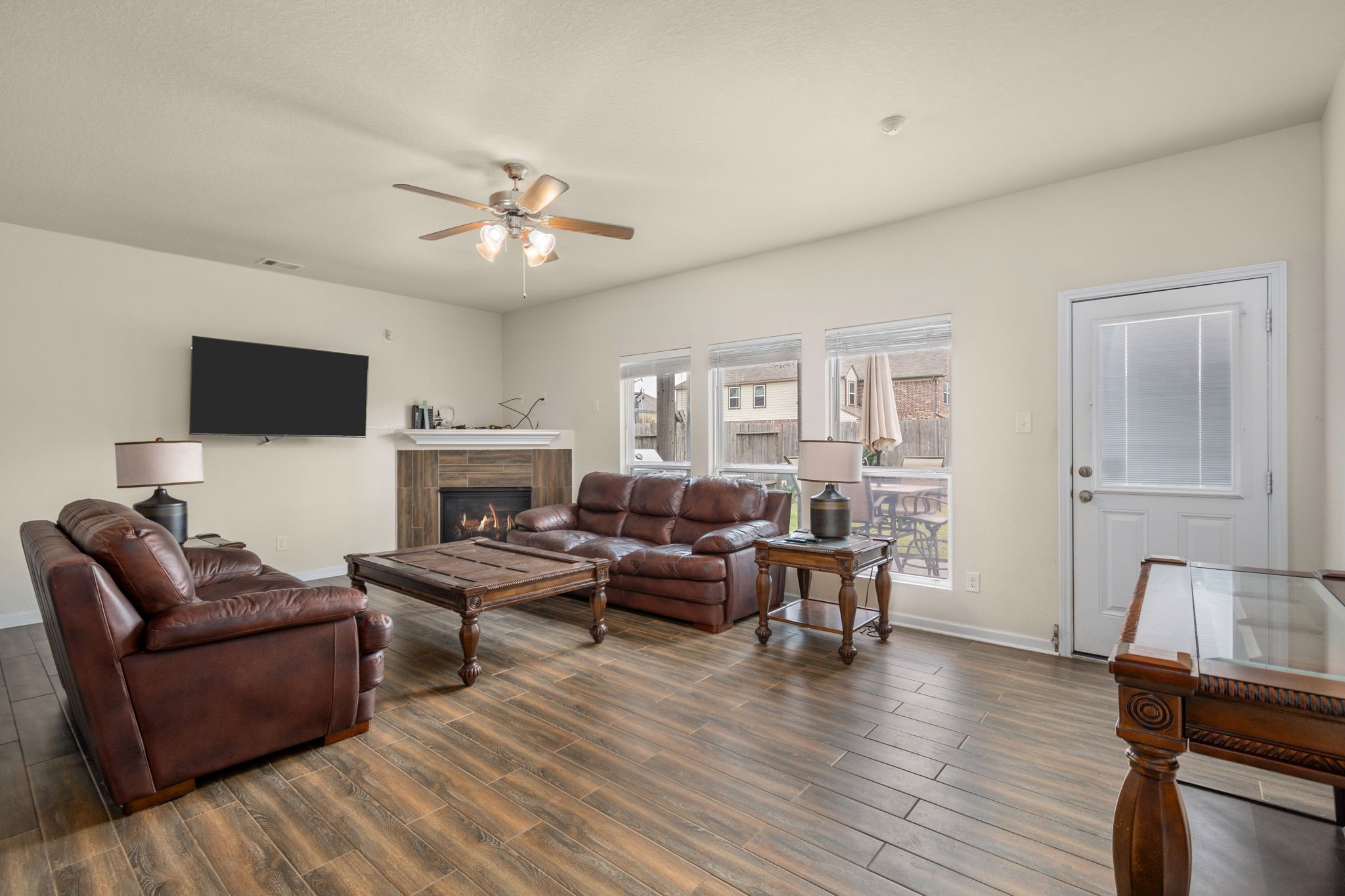 2702 Elm Crossing Trail Spring, TX 77386 - Photo 5 of 21 a living room with furniture a fireplace and a flat screen tv