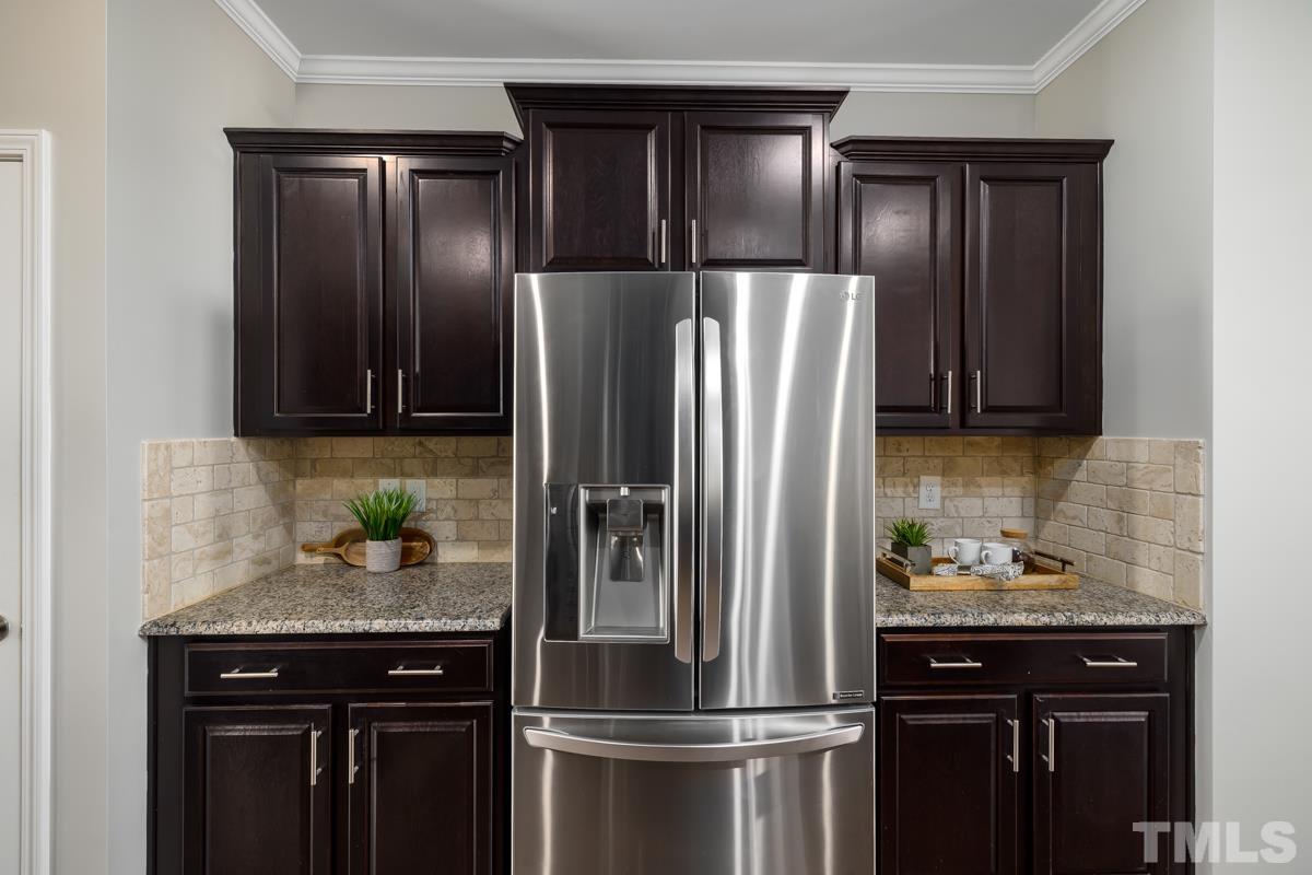 1335 Rodessa Run Raleigh, NC 27607 - Photo 13 of 36 a kitchen with stainless steel appliances granite countertop a refrigerator and a sink