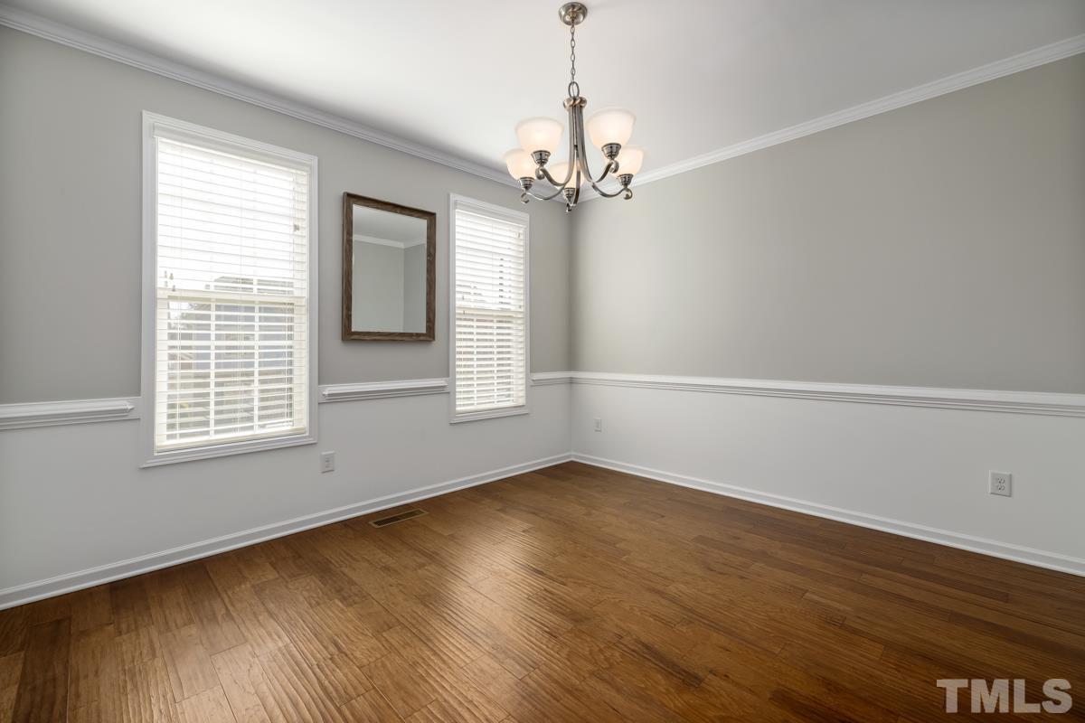 1335 Rodessa Run Raleigh, NC 27607 - Photo 14 of 36 a view of an empty room with wooden floor and a window