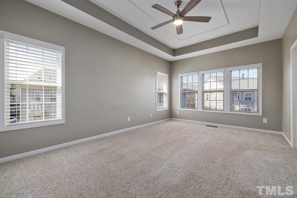 1335 Rodessa Run Raleigh, NC 27607 - Photo 15 of 36 an empty room with windows and ceiling fan
