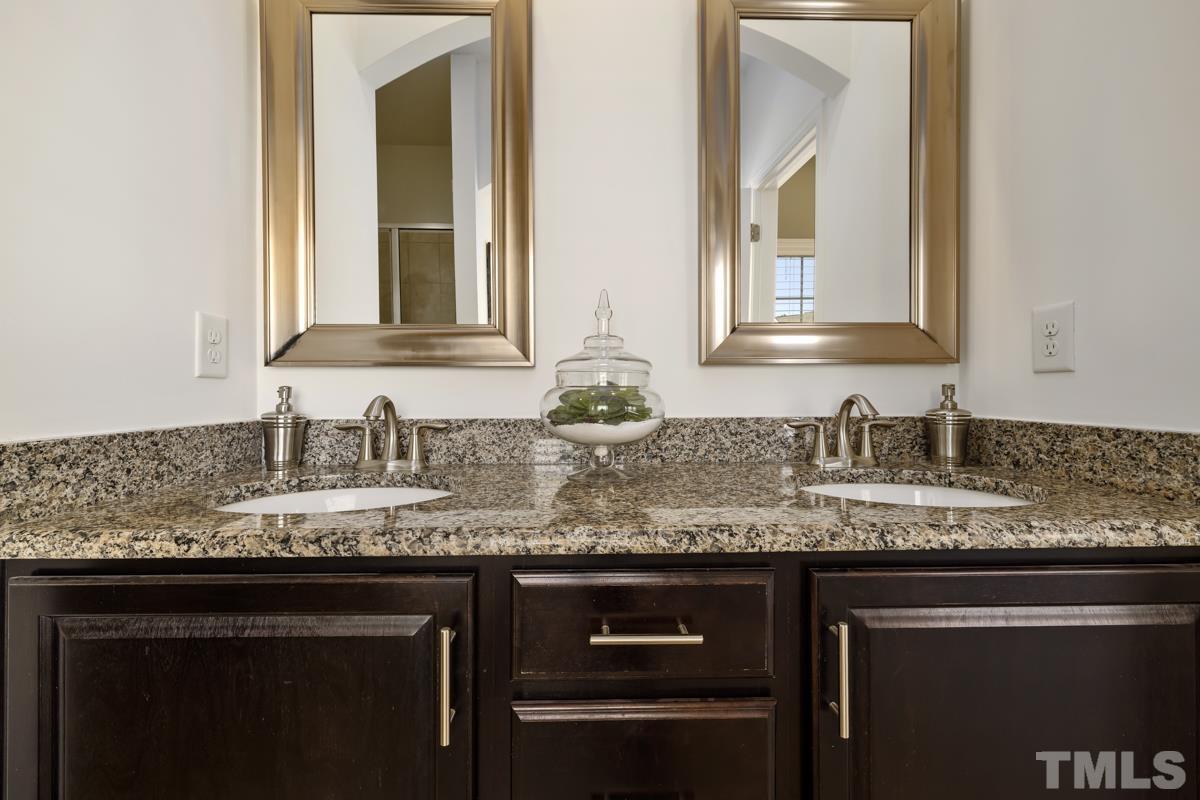 1335 Rodessa Run Raleigh, NC 27607 - Photo 17 of 36 a bathroom with a granite countertop sink and a mirror