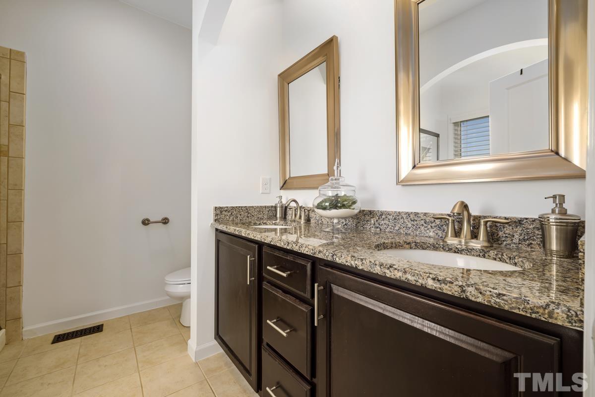1335 Rodessa Run Raleigh, NC 27607 - Photo 18 of 36 a bathroom with a granite countertop sink and a mirror