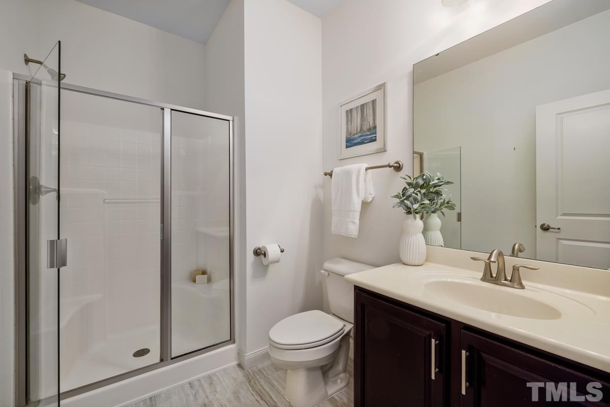 1335 Rodessa Run Raleigh, NC 27607 - Photo 7 of 36 a bathroom with a granite countertop toilet sink and shower