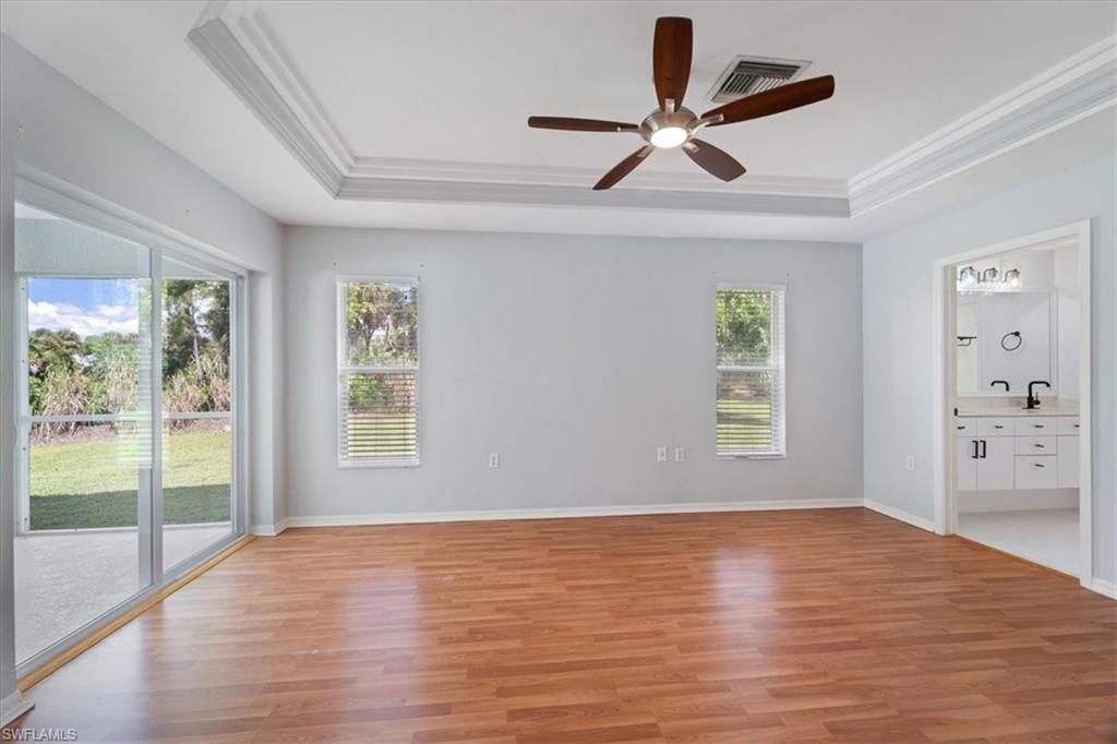 1161 25th Street Southwest Naples, FL 34117 - Photo 11 of 23 a view of empty room with wooden floor and fan