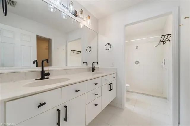 a bathroom with a double vanity sink and a mirror